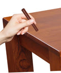 Hand applying Dark Brown Wood Repair Kit Wax Filler Stick on a wooden table surface for Easy To Use No Mess Scratch Repair.
