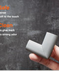Slimfit Baby Proof Edge Protectors And Corner Guards Hit Different For Nursery Safety Using Soft Nbr Rubber Foam Self Adhesive Strips That Lock In Tight, grey corner guard held in hand.