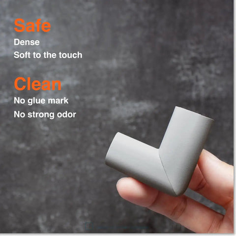 Slimfit Baby Proof Edge Protectors And Corner Guards Hit Different For Nursery Safety Using Soft Nbr Rubber Foam Self Adhesive Strips That Lock In Tight, grey corner guard held in hand.