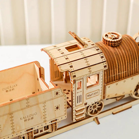 Close-up of 3D Wooden Steam Train Building Set For Adults With Wind Up Mechanical System And Track Rubber Band Powered Locomotive Kit