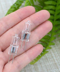 Hand holding Bi-Pin Halogen Bulbs Pack of 10, 12V 10W, 150 Lumens High Output, Dimmable Warm White 2800K, CRI 100