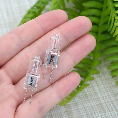 Hand holding Bi-Pin Halogen Bulbs Pack of 10, 12V 10W, 150 Lumens High Output, Dimmable Warm White 2800K, CRI 100