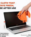 Person cleaning laptop screen with Refillable Screen Cleaner Kit With Microfiber Cloth, 1 Fl Oz Bottle visible beside keyboard.