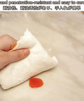 Person wiping a sticky surface with a white cloth demonstrating heavy duty PVC floor protector mat for rolling chairs with slick glide.