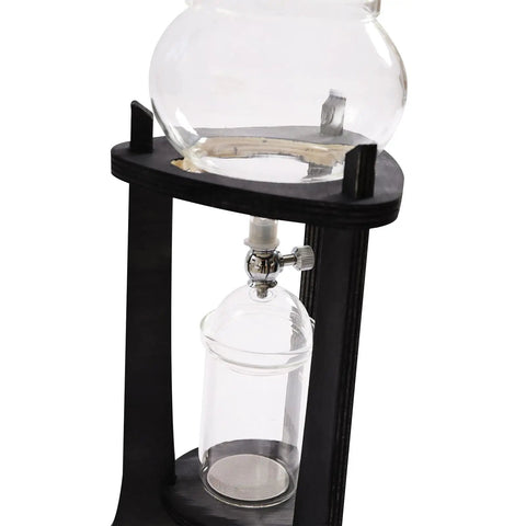 Kick Back And Sip Smooth Chills With This Sharp Cold Brew Drip Coffee Maker Crafted From A Borosilicate Pitcher And Real Wood Stand For Hassle Free Iced Coffee Runs That Come Out Fresh And Totally On Point Daily, showing glass pitcher and wooden stand.