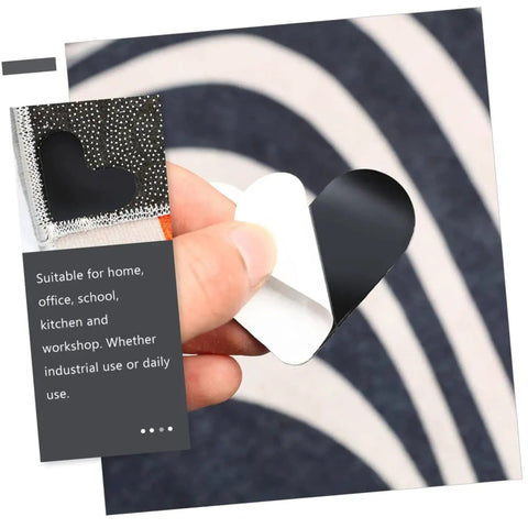 Hand holding heart-shaped non-slip rug tape showing backing design for Heart Shaped Rug Tape Set 8 Pcs No Fuss Non Slip Double Sided Stickers