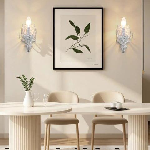 ZIRALIO Farmhouse Vintage Wall Sconce for Bedroom, 2-Pack illuminating a dining area with a wooden table and plant decor.