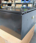 Black 20x16x10 Industrial Control Panel Enclosure, steel, angled view, in warehouse setting, demonstrates durable and weatherproof design.
