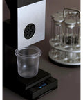 Premium Coffee Bean Counter Dispenser Offers Single Dose And Continuous Modes For Cafe Pros with clear cup on scale.