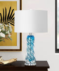 Dope Blue Glass Desk Lamp, 26 Inch Tall With Handcrafted Spiral Body on table with white shade in modern decor