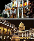 Beautifully illuminated historic buildings at night, showcasing architectural details and vibrant lighting.