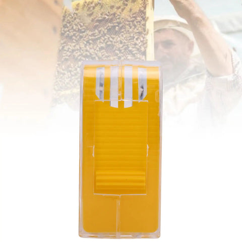 Yellow Queen Bee Marking Kit For Beekeepers One Handed Queen Catcher Bottle Cage visible with blurry beekeeper background