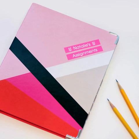 Compact White Label Maker Bundle With Four Tape Rolls For Hassle Free Home And Office Storage Featuring Dead Simple One Touch Keys Quick Print Templates And No Sweat Setup Design For Everyday Clutter Solutions Just Great on a colorful notebook with pencils.