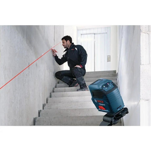 Man using GLL50-RT Self-Leveling Cross Line Laser Renewed, DIY Friendly Setup, Bright Red Beam for Dead-On Indoor Layout on stairs