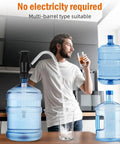 Swap Dead Electric Pumps For This Rugged Hand Operated Drum Pump Designed For Caravan And Rv Sinks Delivering Smooth Dual Action Water Flow To Keep You Quenched While Camping Rough Outside Off Grid. Multi-barrel manual pump in use with water filling a glass.