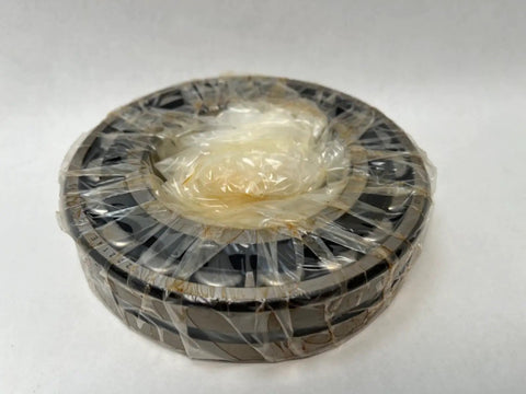 22216 Spherical Roller Bearing With 80mm Inner Diameter and 140mm Outer Diameter Measuring 33mm Wide in plastic wrap.