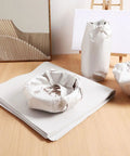 Newspaper Wrapping Paper 50 Sheets for Moving and Shipping displayed with wrapped dishes and pots on a wooden surface.