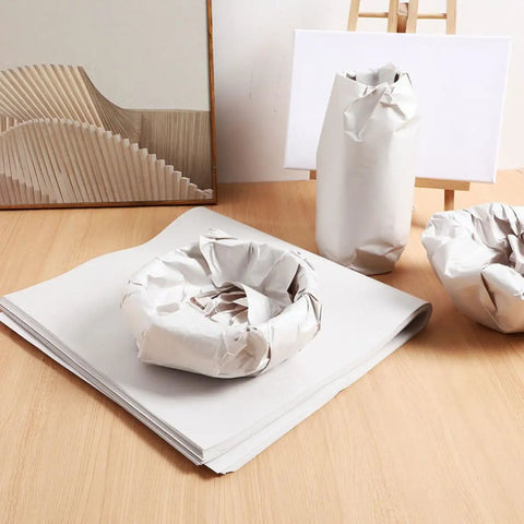 Newspaper Wrapping Paper 50 Sheets for Moving and Shipping displayed with wrapped dishes and pots on a wooden surface.