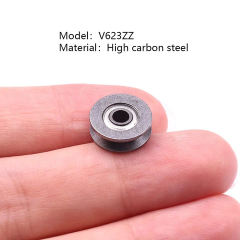 Slick High Carbon Steel V Groove Pulley Wheels Hella Durable Mini Bearings For Low Speed Projects 20 Piece Pack Of 3X12X4Mm Precision Silver Glide Guides in hand.