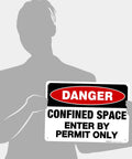 Lock Up Your Worksites With This Sick Danger Confined Space Safety Sign Solid Aluminum Permit Only Plaque held by a person.