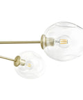 Close-up of Matte Gold Five Light Adjustable Chandelier Pendant With Clear Glass Shades Dope Modern Ceiling Lighting Fixture