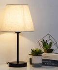 Cozy Two Pack Space Saving Bedside Table Lamp With Fabric Shade, 15 Inch Nightstand Lamp on table with potted plants in background