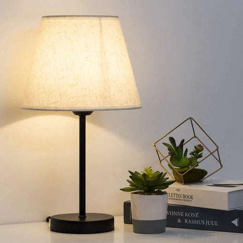 Cozy Two Pack Space Saving Bedside Table Lamp With Fabric Shade, 15 Inch Nightstand Lamp on table with potted plants in background