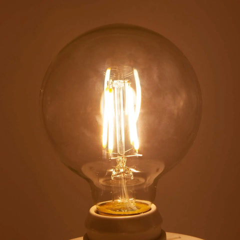 G25 LED Filament Vanity Bulb 40W Equivalent, 500 Lumens, 2700K Warm White, E26 Edison Base, glowing in warm light