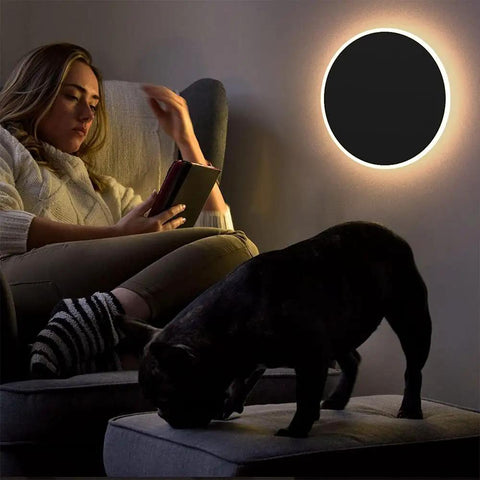 Modern Black Touch Sensor LED Wall Sconce 10W 3000K Hardwired Indoor Light illuminating a room with a woman reading