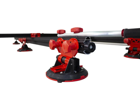 Close-up of heavy duty slab conveyor for transporting ceramic sheets and large format tiles, featuring adjustable red supports.