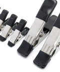 Angled view of Amazon Basics steel spring clamp set: eight clamps with black PVC-coated tips and silver bodies