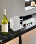 Plug And Play Electric Pvc Bottle Cap Heat Shrinker 110V Tabletop Sealer Adjustable Temp on a marble table with a green wine bottle.