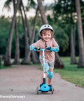 Kid Friendly Knee And Elbow Pad Set With Pro Grade Bike Gloves For Ages 2-11 All Day Fun Flexible Impact Resistant Protective Gear For Balance Bikes Roller Skating And Skateboarding Dinosaur Design Small on child riding scooter outdoors.