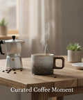 Premium Durable Ceramic Espresso Cup With Wooden Handle 1.7 Oz Demitasse with steam on wooden table next to coffee maker.