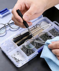 Image of a person using Glasses Repair Kit 500 Pieces With Assorted Screws, Nose Pads, Mini Screwdrivers, Tweezers, Cleaning Cloth And Case.
