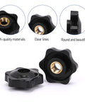 Two black 1/4-20 star-shaped clamping knobs with brass threaded inserts.