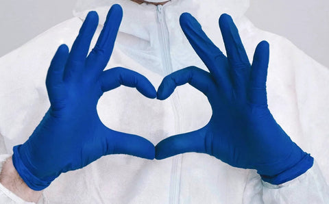 Front view: pair of cobalt blue nitrile medical-examination gloves forming a heart; latex-free