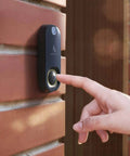 Hand pressing Photo Doorbell With Indoor Chime, Get Still Image Snaps When Motion Or Doorbell Is Detected, installed on brick wall