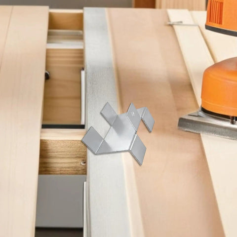 Four Piece No Drill Fence Brackets With Gravel Board Clips, Metal Anti Rattle Hardware for outdoor fences on a workbench