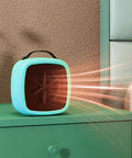 Tiny But Mighty Compact Ceramic Space Heater 500W in yellow on green desk with heat waves visible, for cozy warmth and safety.