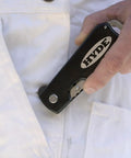Dual Blade Folding Painter Tool Five In One Stainless Steel Multi Tool with Flexible Putty Knife in pocket close-up