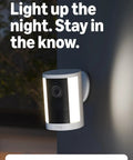 Heavy Duty Wireless Security Cam With Slick 2K Retinal Footage Badass Night Lights mounted on wall with illuminated spotlight.