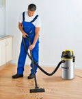 Man using Heavy Duty Wet Dry Vacuum With 4 HP Motor, 4.5 Gallon Stainless Steel Tank, Wall Mountable for cleaning kitchen floor