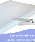 White ceramic fiber paper sheet for kiln insulation, 24 x 33 x 0.08 in, 3-pack, being cut with scissors.