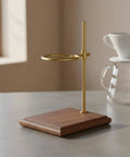 Premium Walnut Coffee Dripper Stand Adjustable Pour Over Holder With Matte Copper Aluminum Bracket and Textured Loop, side view on countertop.