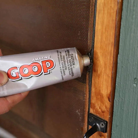 Person applying All Purpose Glue 3.7oz Clear Bundle With Snip Tip Applicators And Spreader Tools to screen door for heavy duty bonds.