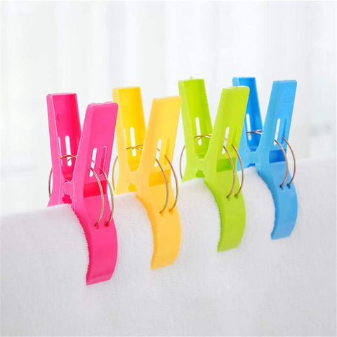 Colorful heavy duty beach towel clips for chairs and loungers securing towel, windproof clips to keep towels, swimsuits, and gear from blowing away.