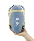 Ultralight Backpacking Sleeping Bag For 50 To 70 F Weather, 1.5 Lb Packable To 11.8 X 6.5 Inches held in hand showing size