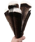 Hand holding Natural Turkey Tail Feathers 12 Pack Long 8 To 10 Inches Bulk Feathers for Crafts DIY Wedding Decor Fly Tying Costumes