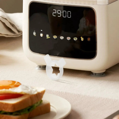Six Point Star Ice Cream Nozzle Replacement For Soft Serve Machines with hexagon shaping tip beside a kitchen timer display.